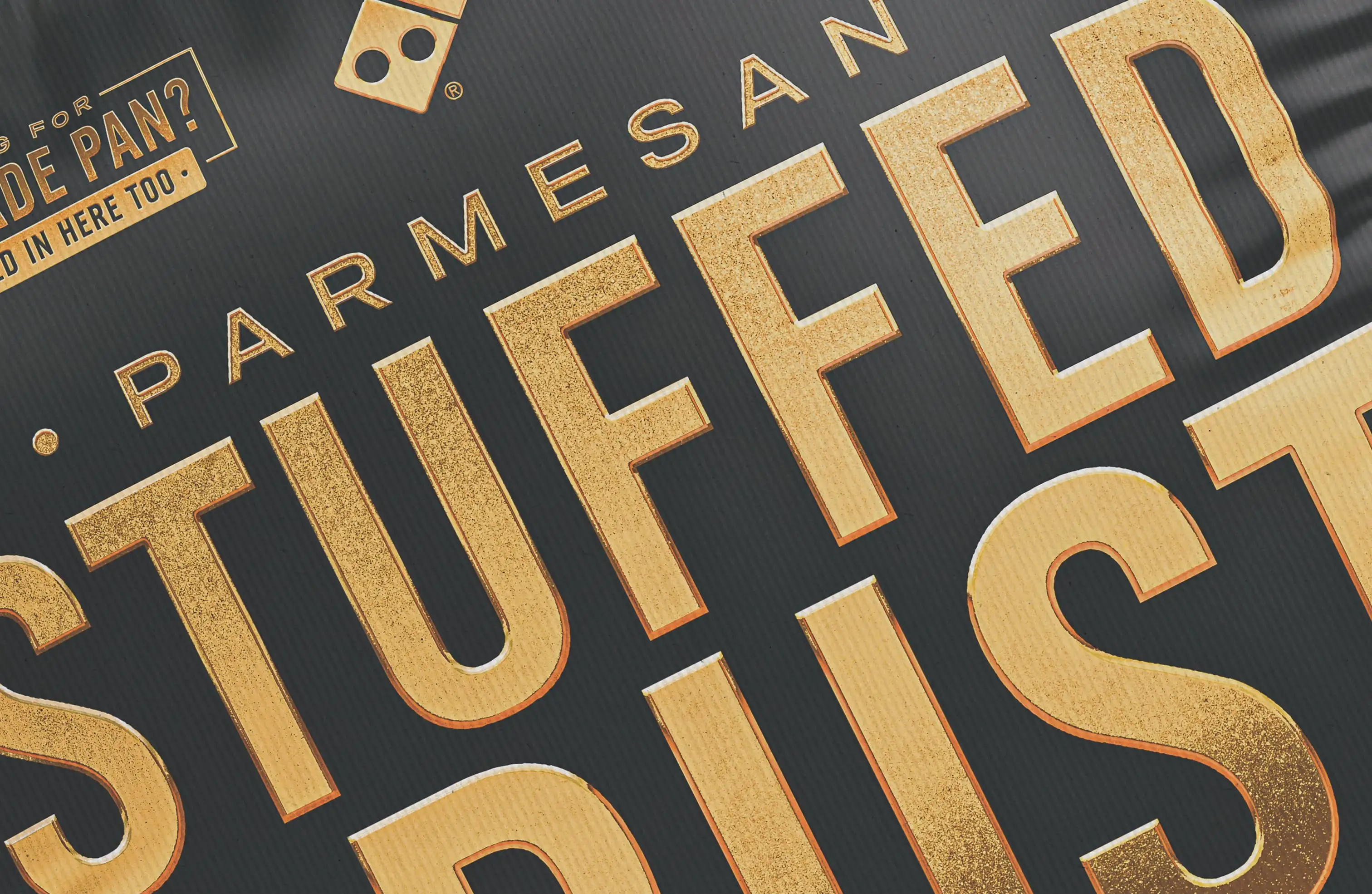 Dominos pizza box with Parmesan Stuffed Crust in gold lettering